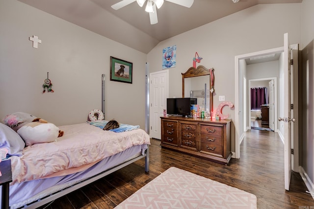 bedroom featuring dark hardwood / wood-style floors, vaulted ceiling, and ceiling fan