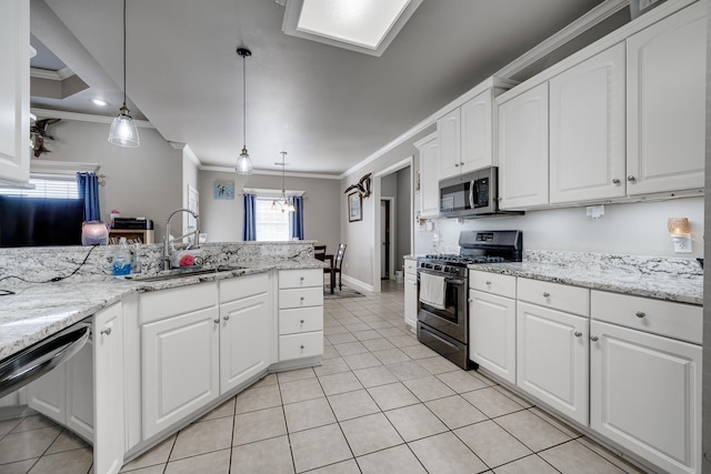 kitchen with dishwashing machine, gas range oven, pendant lighting, and white cabinetry