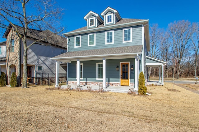 view of front of house with covered porch and a front yard