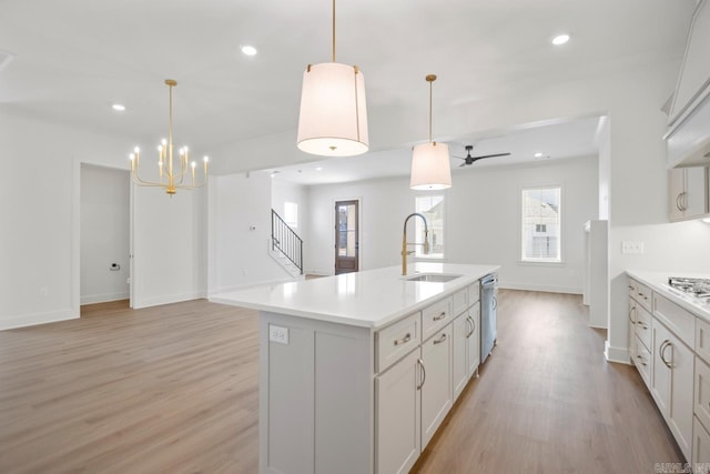 kitchen featuring sink, a center island with sink, pendant lighting, and dishwasher