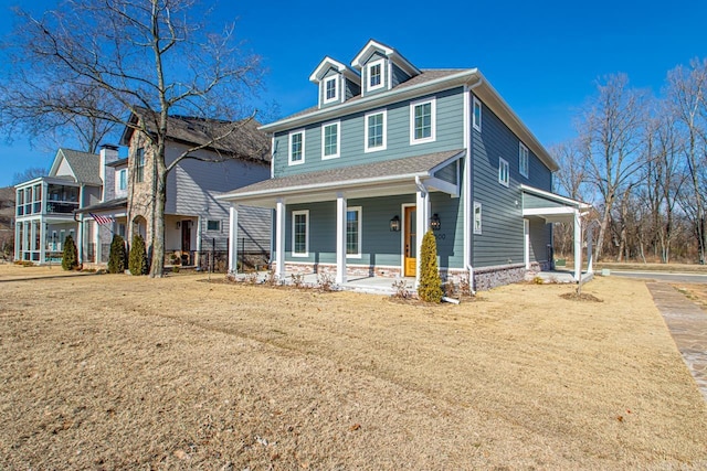 view of front of house with a porch and a front yard