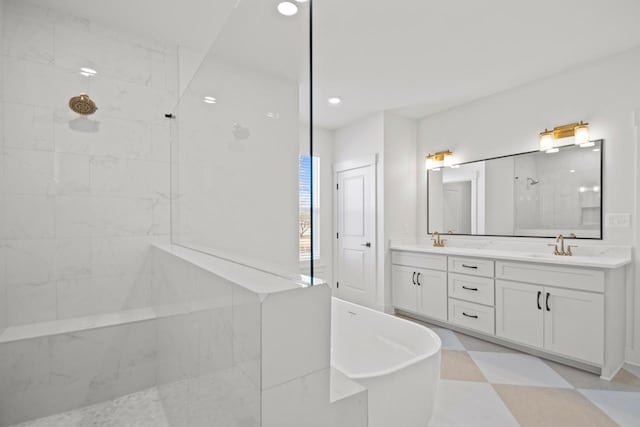 bathroom featuring vanity and independent shower and bath