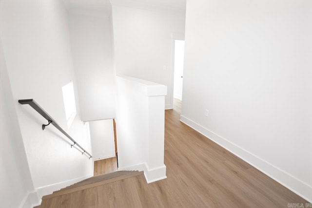 stairs featuring hardwood / wood-style floors