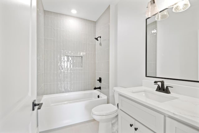 full bathroom with tile patterned floors, tiled shower / bath combo, vanity, and toilet