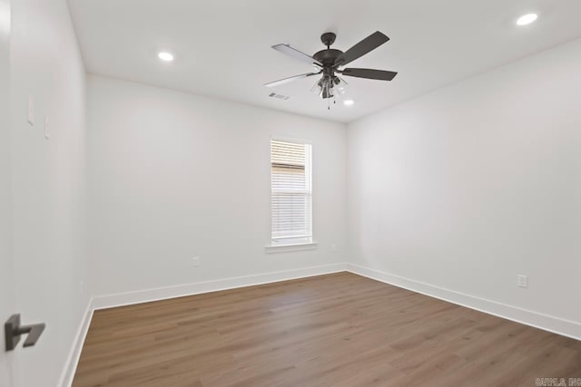 spare room featuring ceiling fan and hardwood / wood-style floors