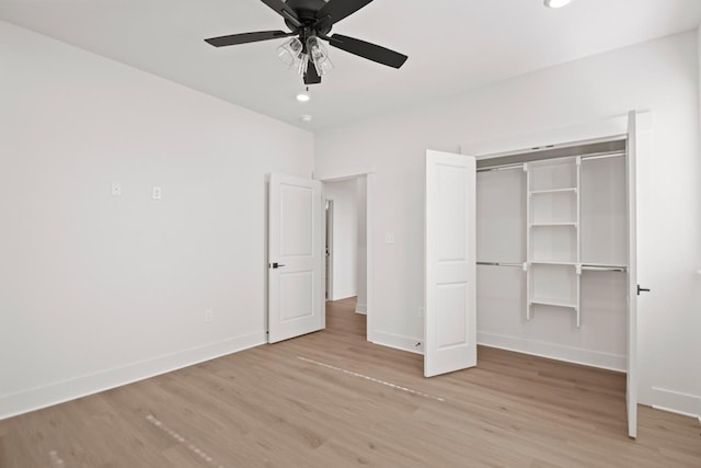 unfurnished bedroom with ceiling fan, light hardwood / wood-style flooring, and a closet