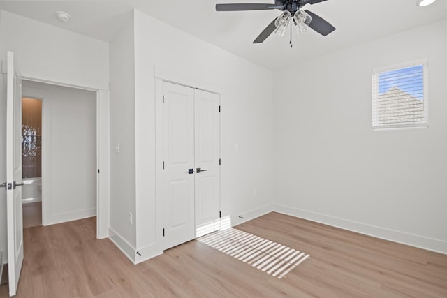 unfurnished bedroom featuring light wood-type flooring, a closet, and ceiling fan