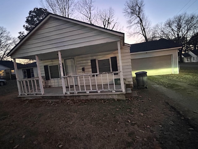 view of front facade with covered porch and a garage