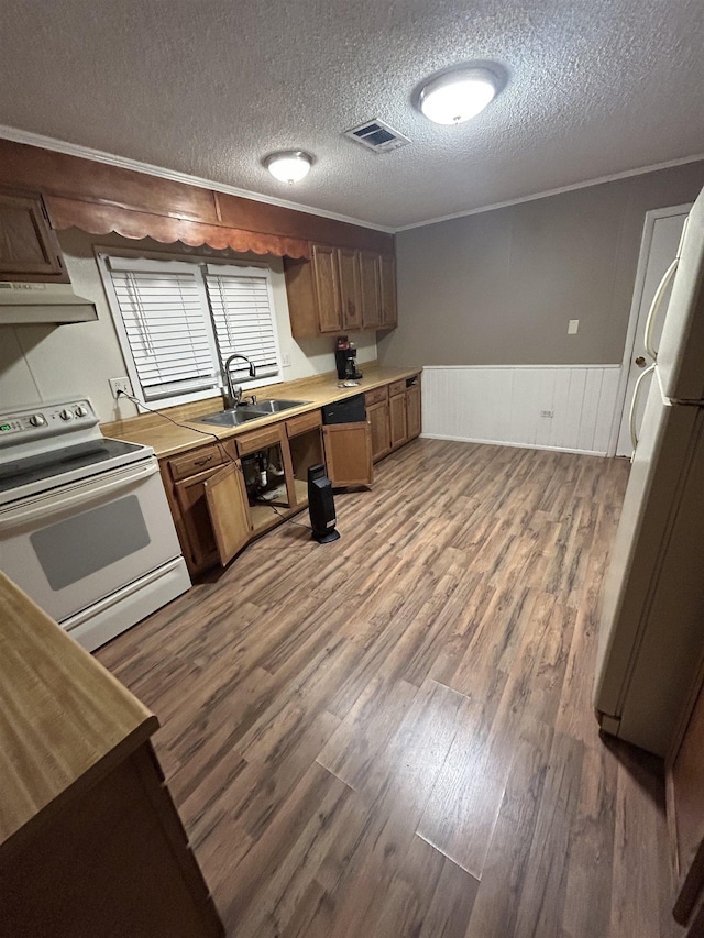 kitchen featuring refrigerator, hardwood / wood-style floors, white electric range oven, built in desk, and sink