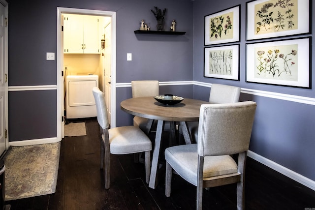 dining space with dark hardwood / wood-style flooring and washer / dryer