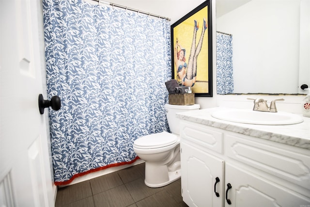 bathroom featuring toilet, tile patterned floors, and vanity