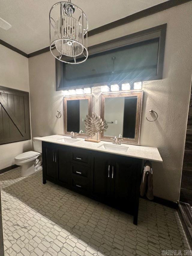 bathroom featuring toilet, a shower, ornamental molding, an inviting chandelier, and vanity