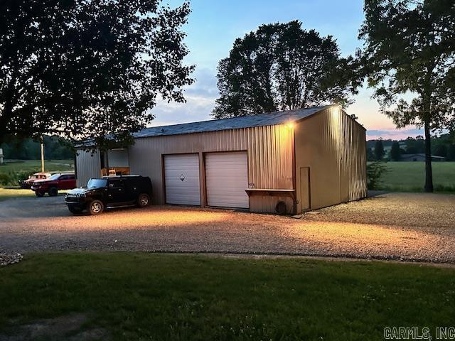 view of garage at dusk