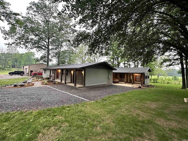 rear view of house with a porch and a lawn