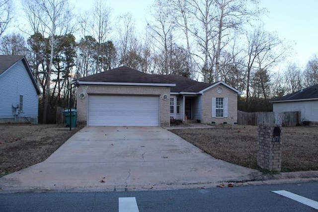 ranch-style house featuring crawl space, brick siding, driveway, and an attached garage