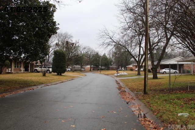 view of road featuring curbs and a residential view