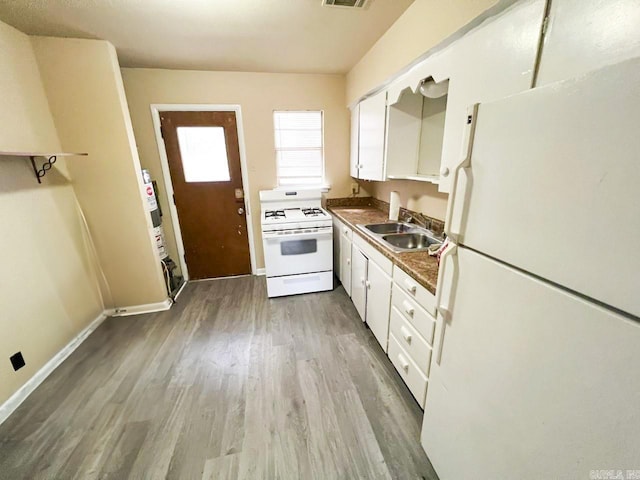 kitchen featuring sink, white appliances, white cabinets, and wood-type flooring