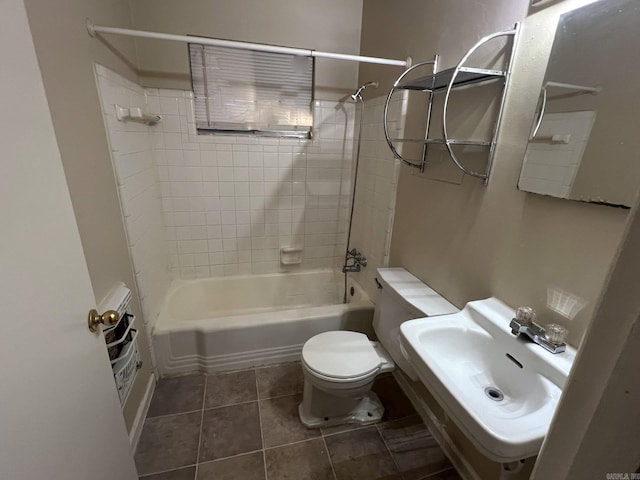 full bathroom featuring sink, toilet, tiled shower / bath, and tile patterned flooring