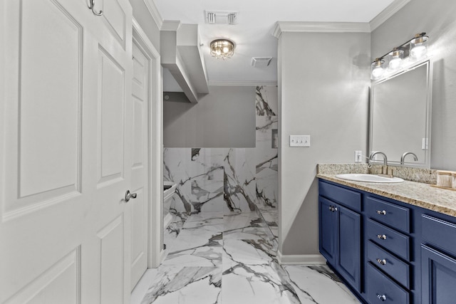 bathroom with ornamental molding and vanity