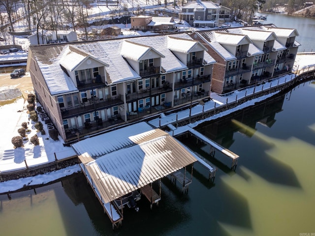 snowy aerial view with a water view