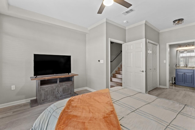 bedroom featuring sink, ceiling fan, connected bathroom, ornamental molding, and light hardwood / wood-style floors