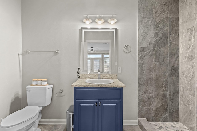 bathroom featuring vanity, toilet, and a tile shower