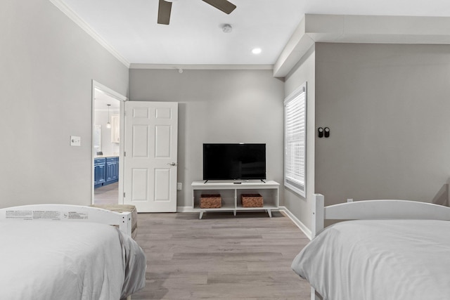 bedroom with crown molding, light hardwood / wood-style flooring, and ceiling fan