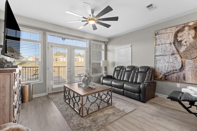 living room with french doors, ceiling fan, crown molding, and light hardwood / wood-style floors