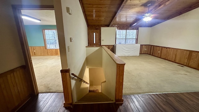 interior space with beamed ceiling, wooden ceiling, and ceiling fan