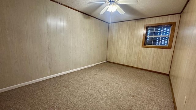 carpeted spare room with crown molding, ceiling fan, and a textured ceiling