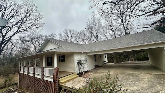 view of side of home with a carport