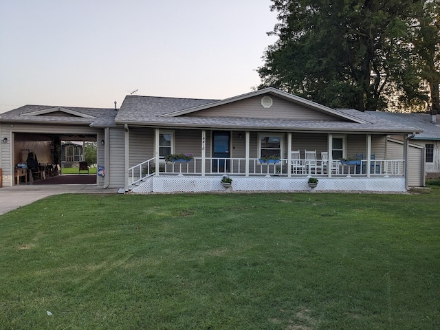 ranch-style home featuring a carport, a porch, and a yard