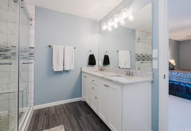 bathroom with a shower with door and vanity