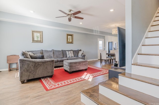 living room with light hardwood / wood-style floors and ceiling fan