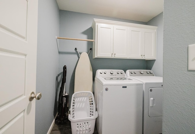 laundry room featuring cabinets and separate washer and dryer