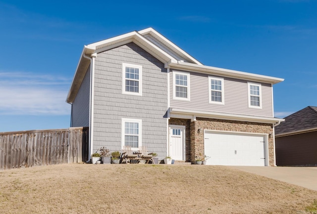 view of front of home featuring a garage and a front yard