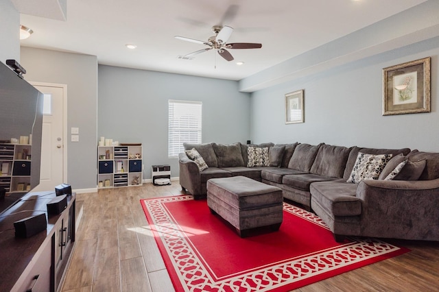 living room with hardwood / wood-style floors and ceiling fan