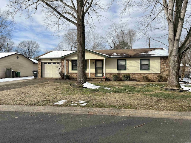 single story home with a garage and a front lawn