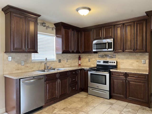 kitchen with stainless steel appliances, sink, and backsplash