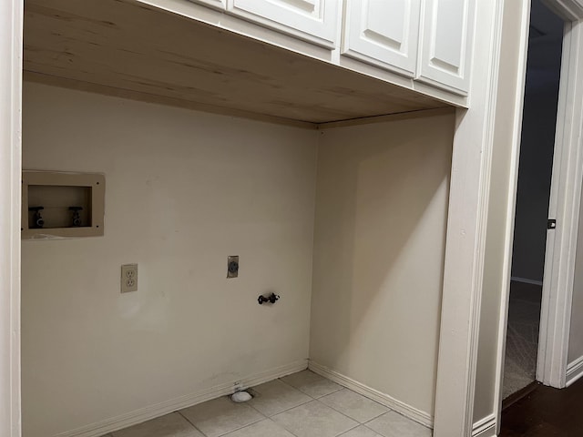 clothes washing area with cabinets, washer hookup, light tile patterned floors, and electric dryer hookup