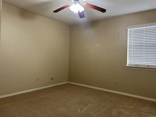 spare room featuring ceiling fan and carpet flooring