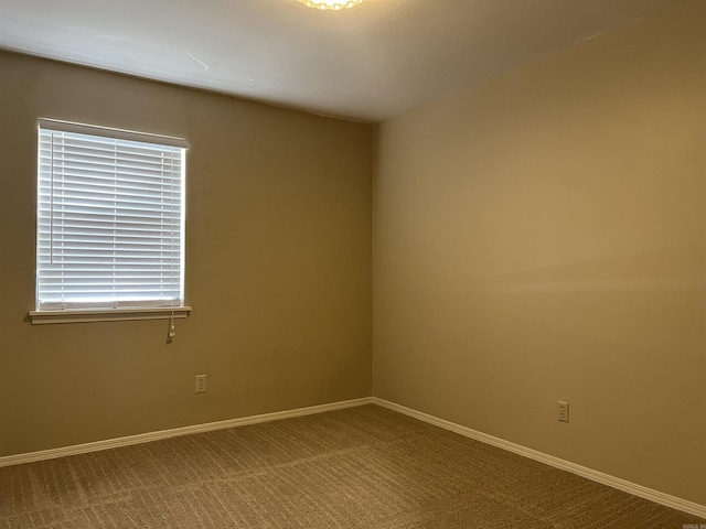 carpeted spare room with a healthy amount of sunlight