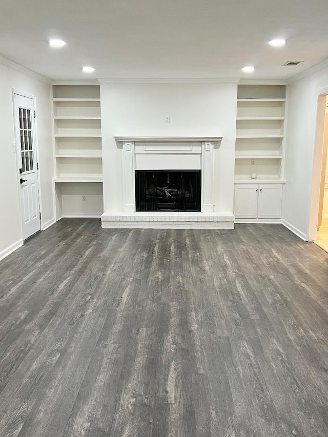 unfurnished living room featuring ornamental molding and dark hardwood / wood-style floors