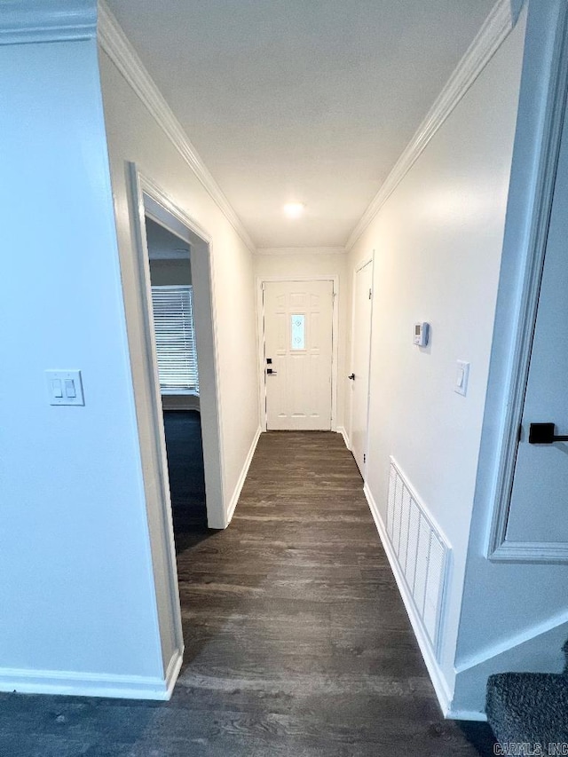 hallway with ornamental molding and dark hardwood / wood-style floors