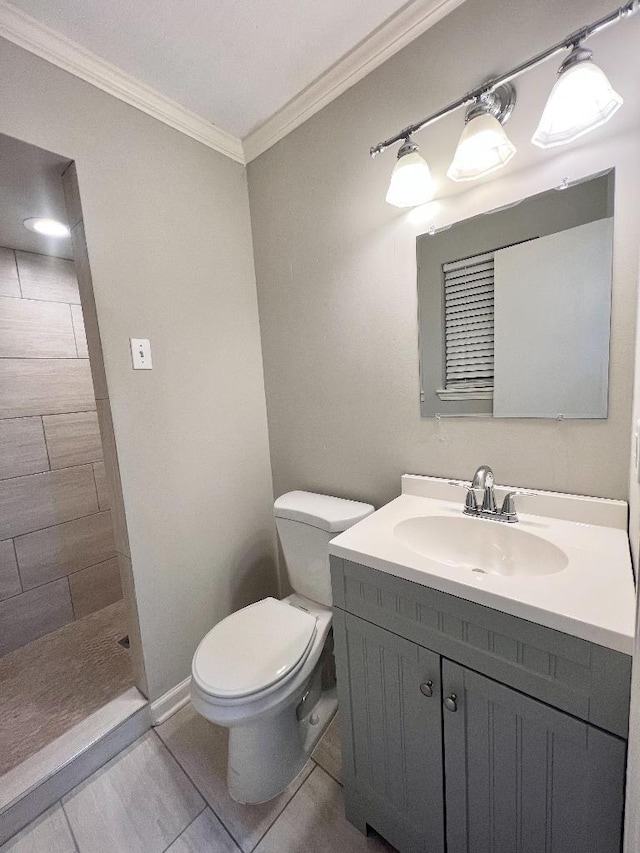 bathroom featuring a shower, ornamental molding, vanity, toilet, and tile patterned floors