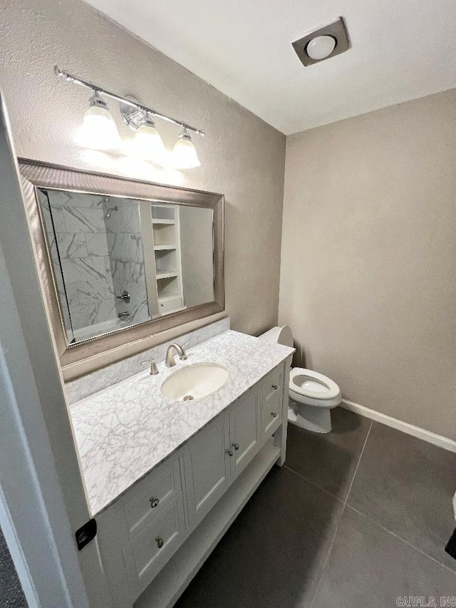 bathroom with tile patterned floors, toilet, and vanity