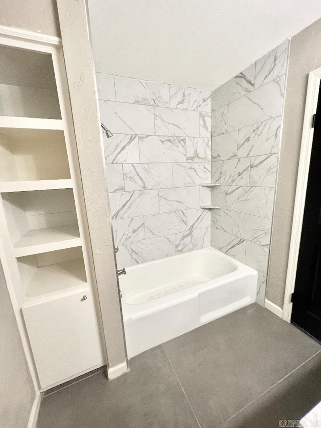 bathroom featuring tile patterned floors and tiled shower / bath