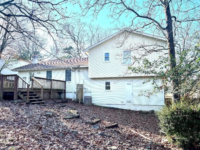 rear view of house featuring a deck and central air condition unit