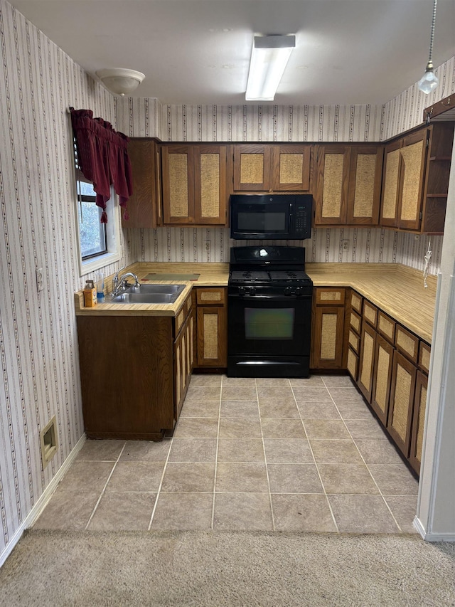 kitchen featuring light tile patterned floors, sink, hanging light fixtures, and black appliances