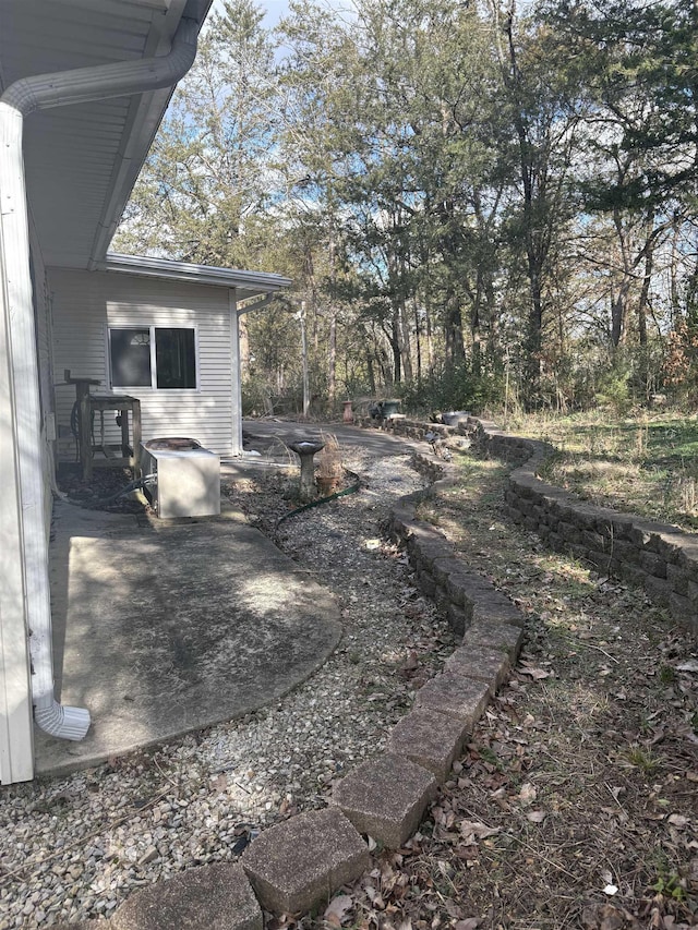 view of yard featuring a patio and central AC unit